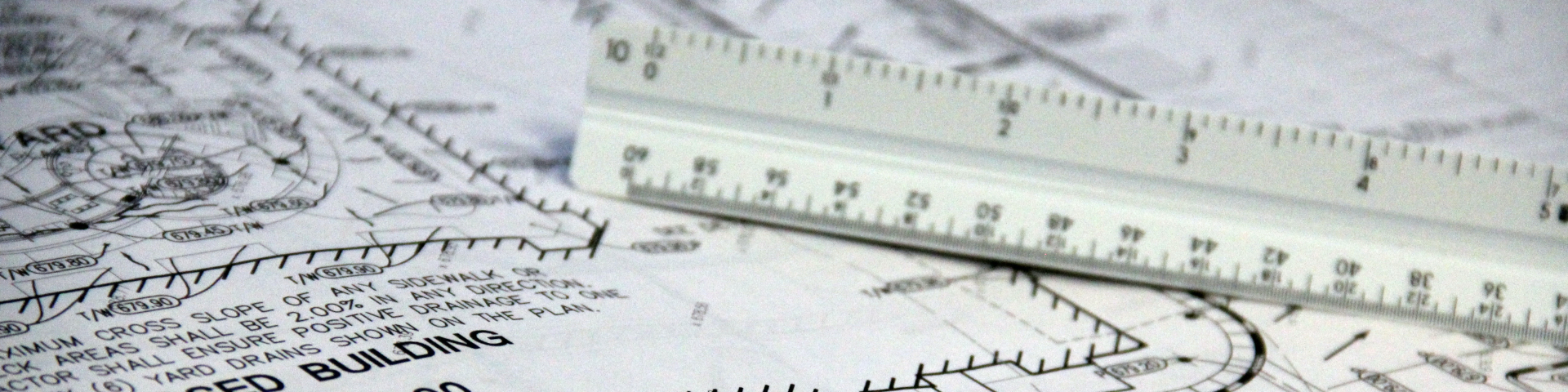 engineer scale laying on top of landscaping plan for a building